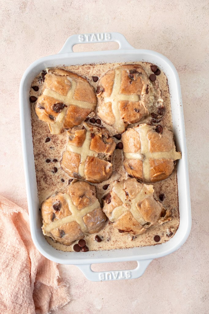 The hot cross buns soaking in the custard mixture before baking.