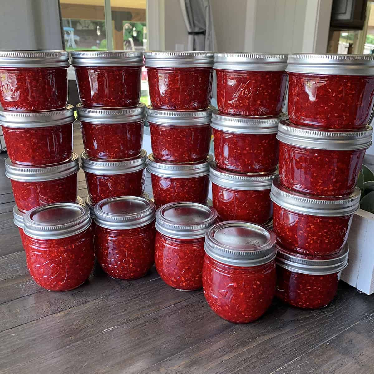 Homemade raspberry freezer jam from freshly grown raspberries.