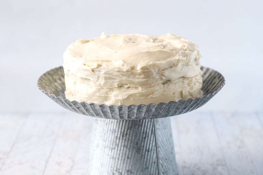 old fashioned red velvet cake on a cake stand