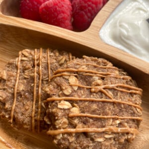 Peanut butter cookies served with raspberries and yogurt
