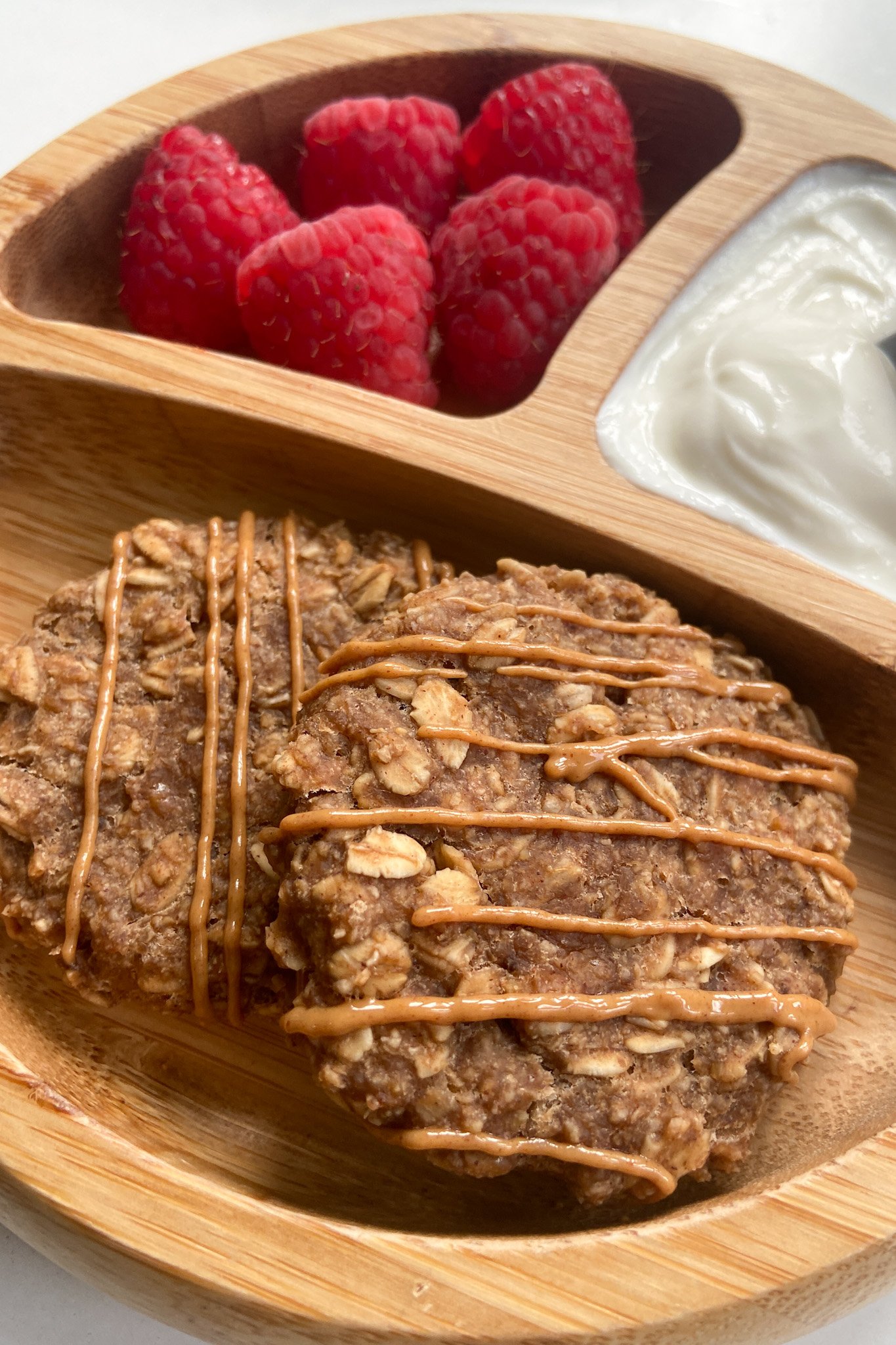 Peanut butter cookies served with raspberries and yogurt