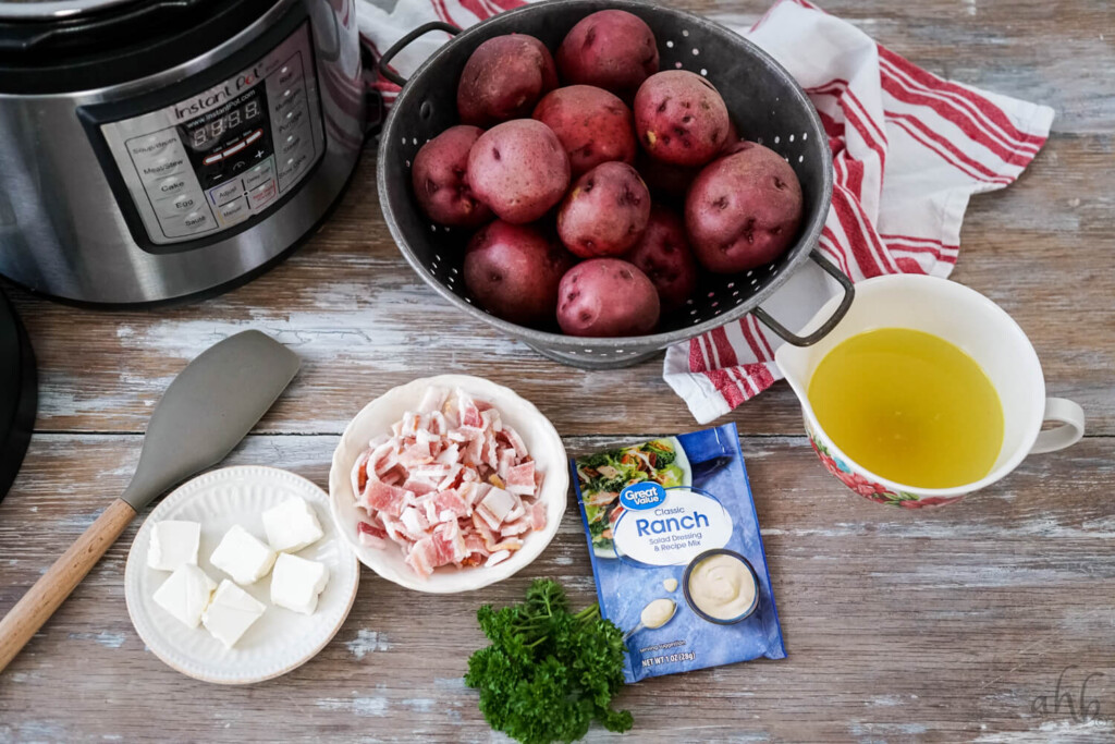 The ingredients needed to make instant pot ranch potatoes siting next to the instant pot.
