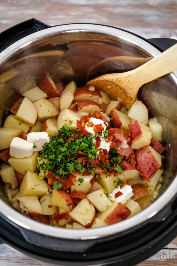 After cooking, the bacon, parsley and cream cheese are added to the instant pot.