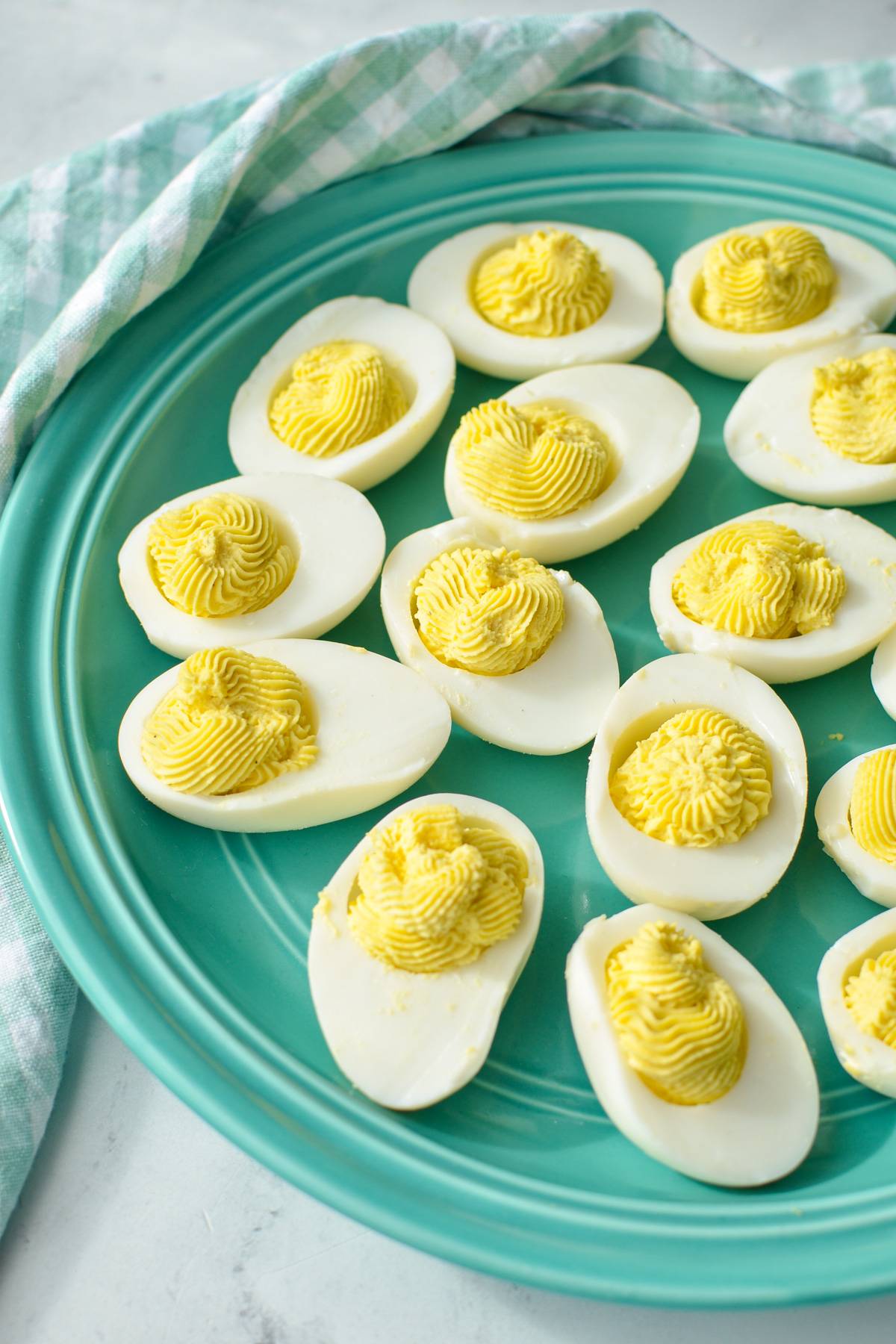 An aqua colored plate of deviled eggs.