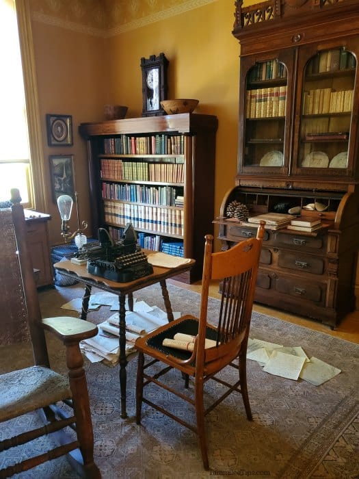 John muir office with table, typewriter, bookshelves, and shelves of books