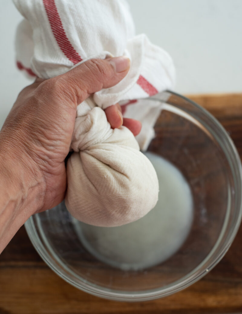 Firm tofu wrapped in a kitchen cloth and squeezed to remove moisture
