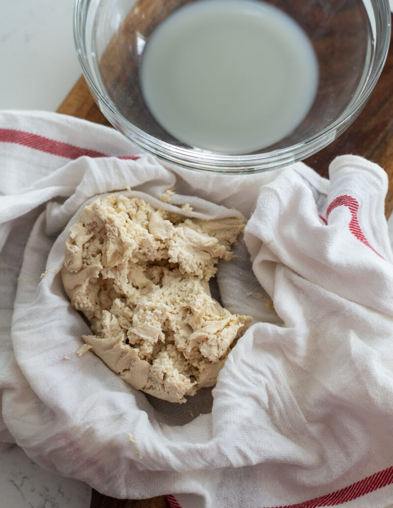 Crumbled firm tofu in a kitchen cloth after squeezing out moisture 