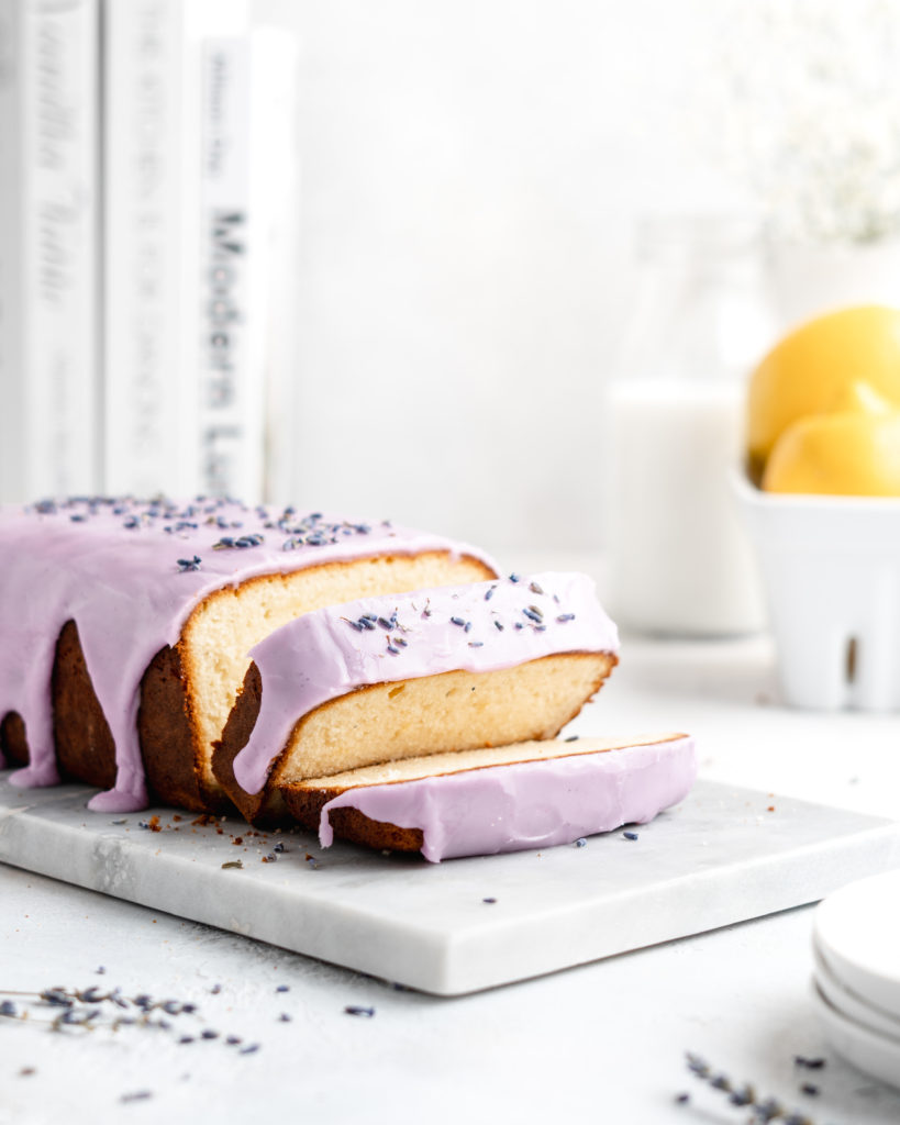 Fluffy and moist Lemon and lavender loaf cake is glazed in a purple coloured vanilla glaze