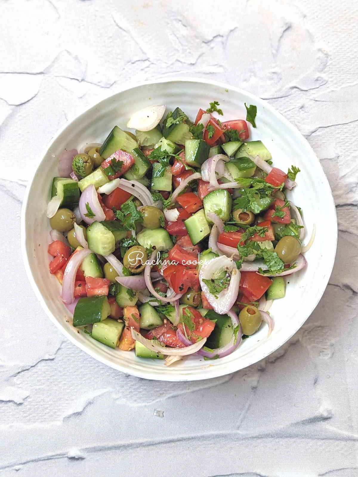 Mediterranean cucumber tomato salad served in a bowl.