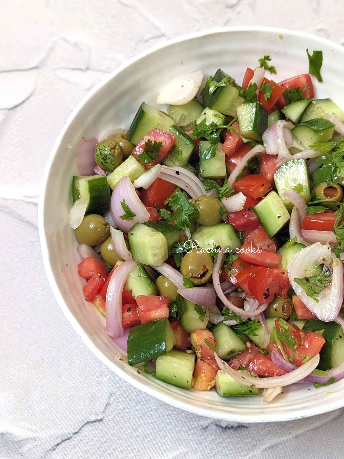 A bowl fo Mediterranean cucumber tomato salad.