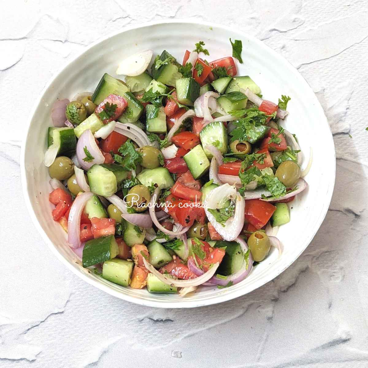 Mediterranean cucumber tomato salad served in a bowl.