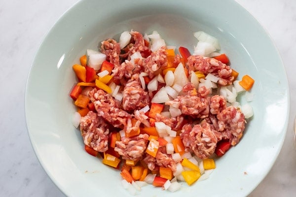 Sausage and vegetables in a microwave safe bowl