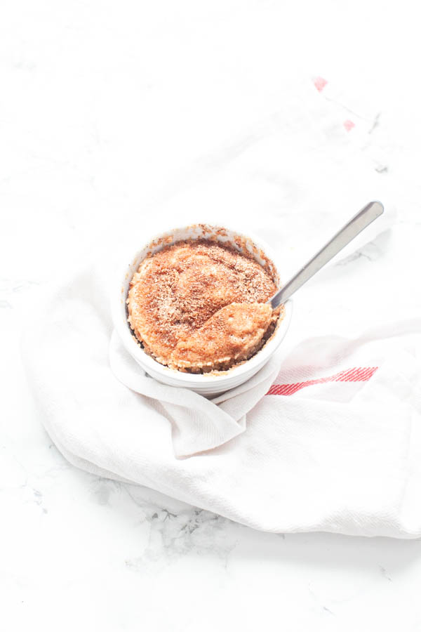 Microwave Snickerdoodle mug cake in a white mug with a spoon