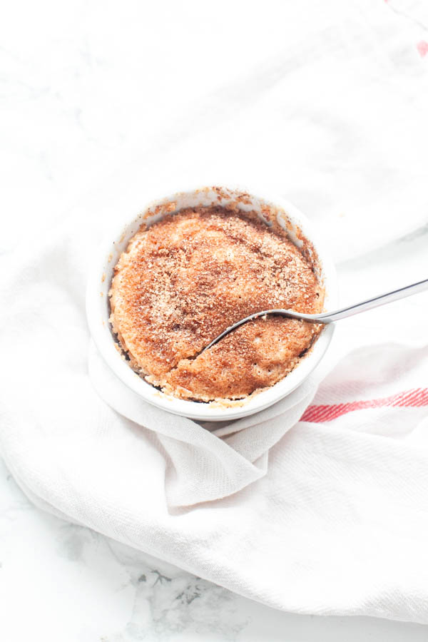 Microwave Snickerdoodle mug cake in a white mug with a spoon