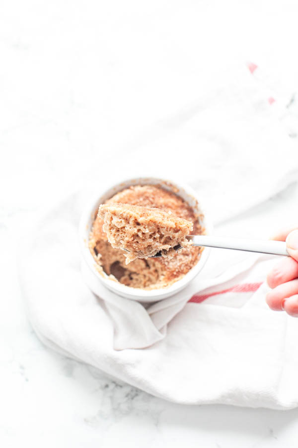 Microwave Snickerdoodle mug cake in a white mug with a spoon
