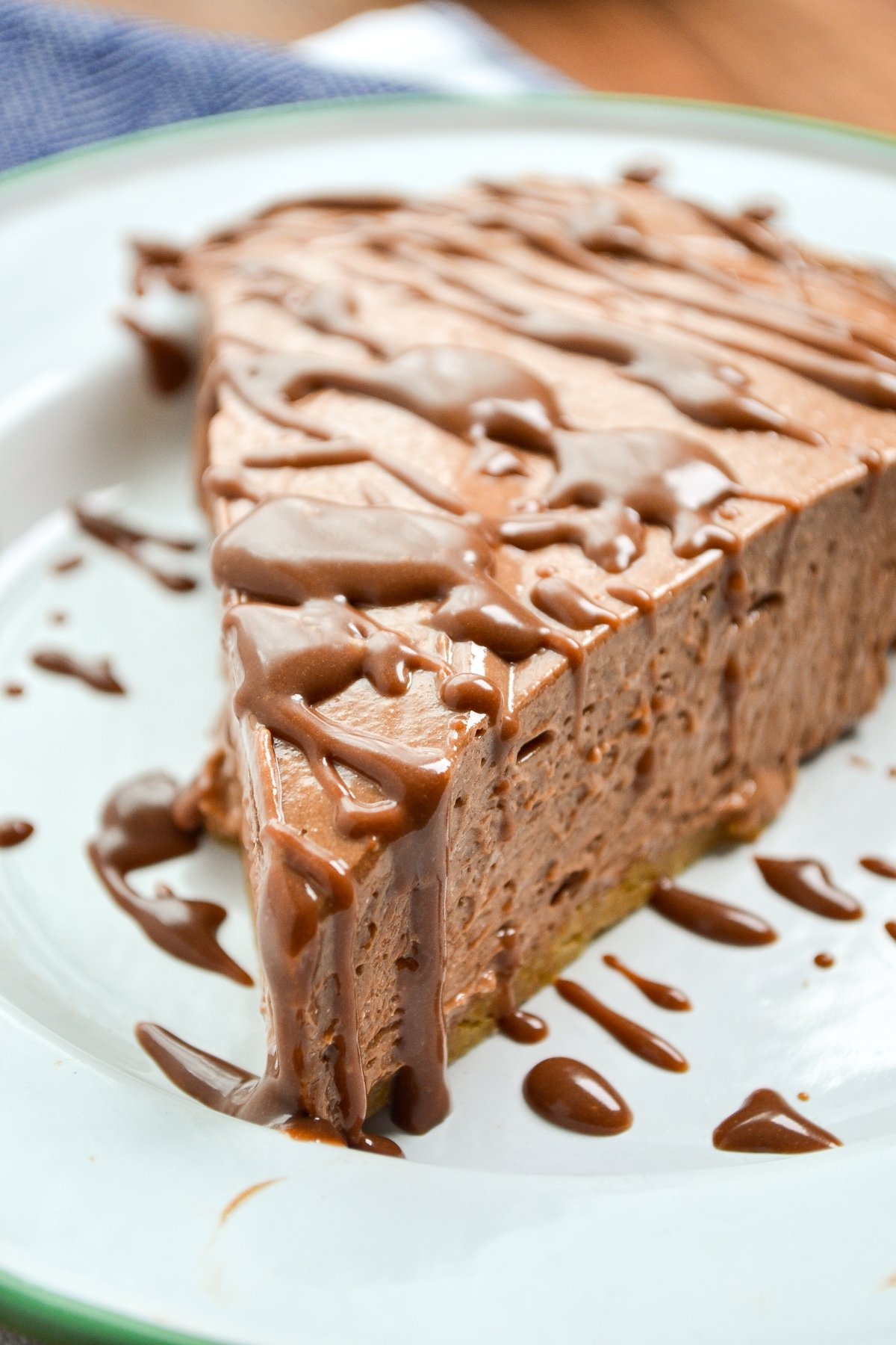 A slice of nutella pie topped with a nutella ganache.