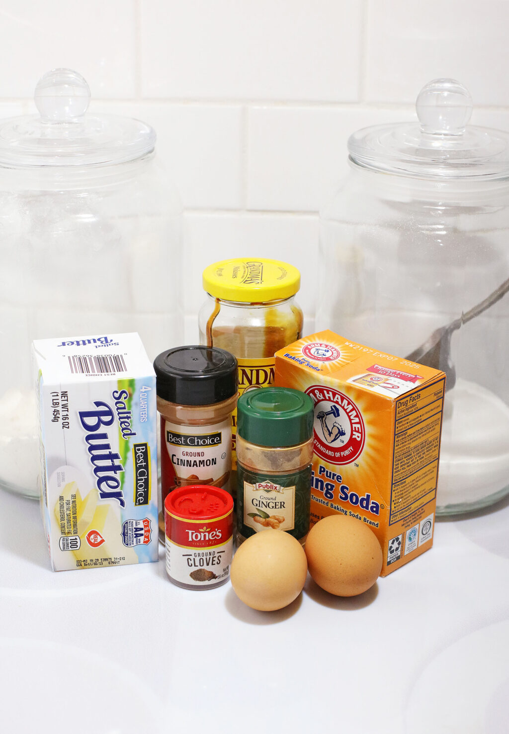 gingersnap cookies ingredients on white table