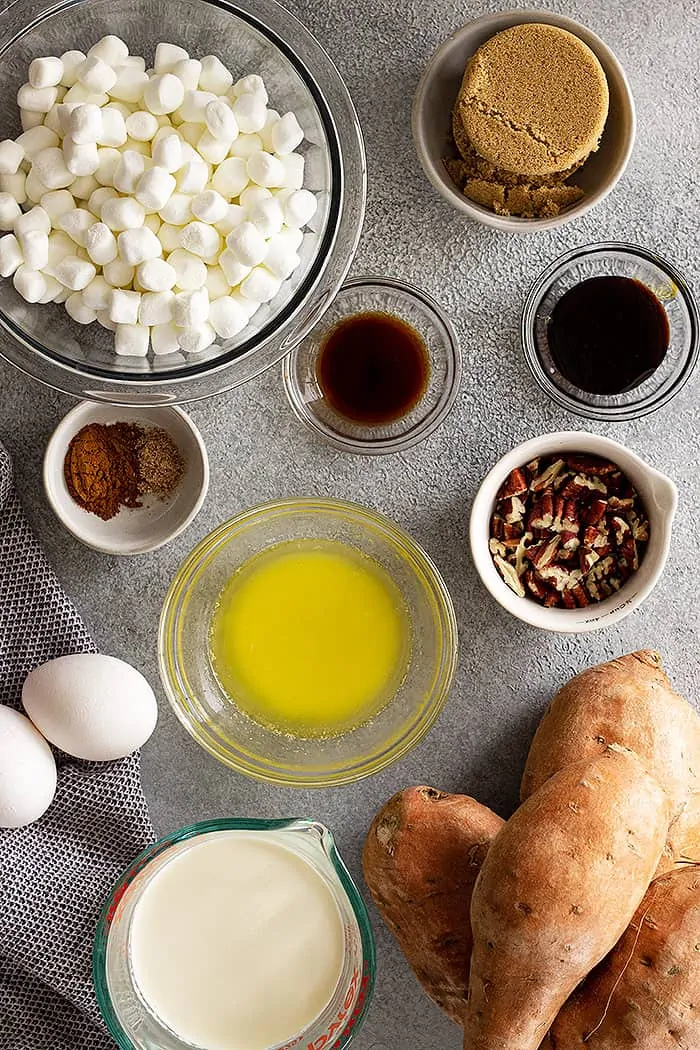 overhead: ingredients for old fashioned sweet potato casserole with pecan topping in several bowls