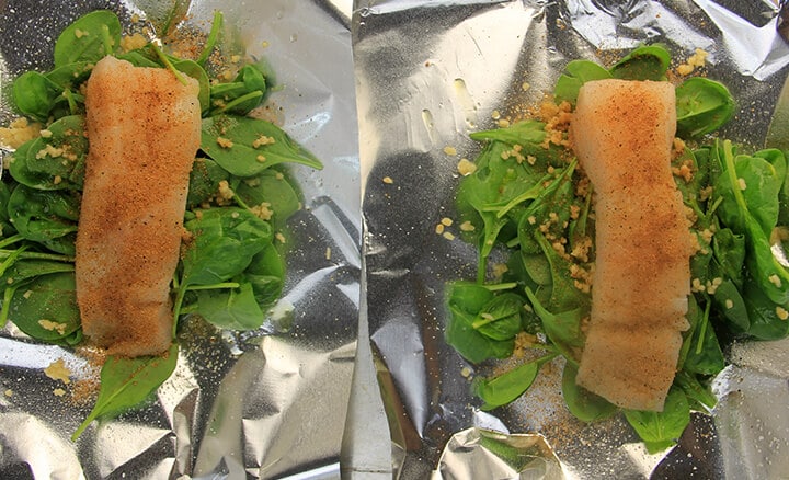 Fish fillets on top of spinach to make baked fish packets.