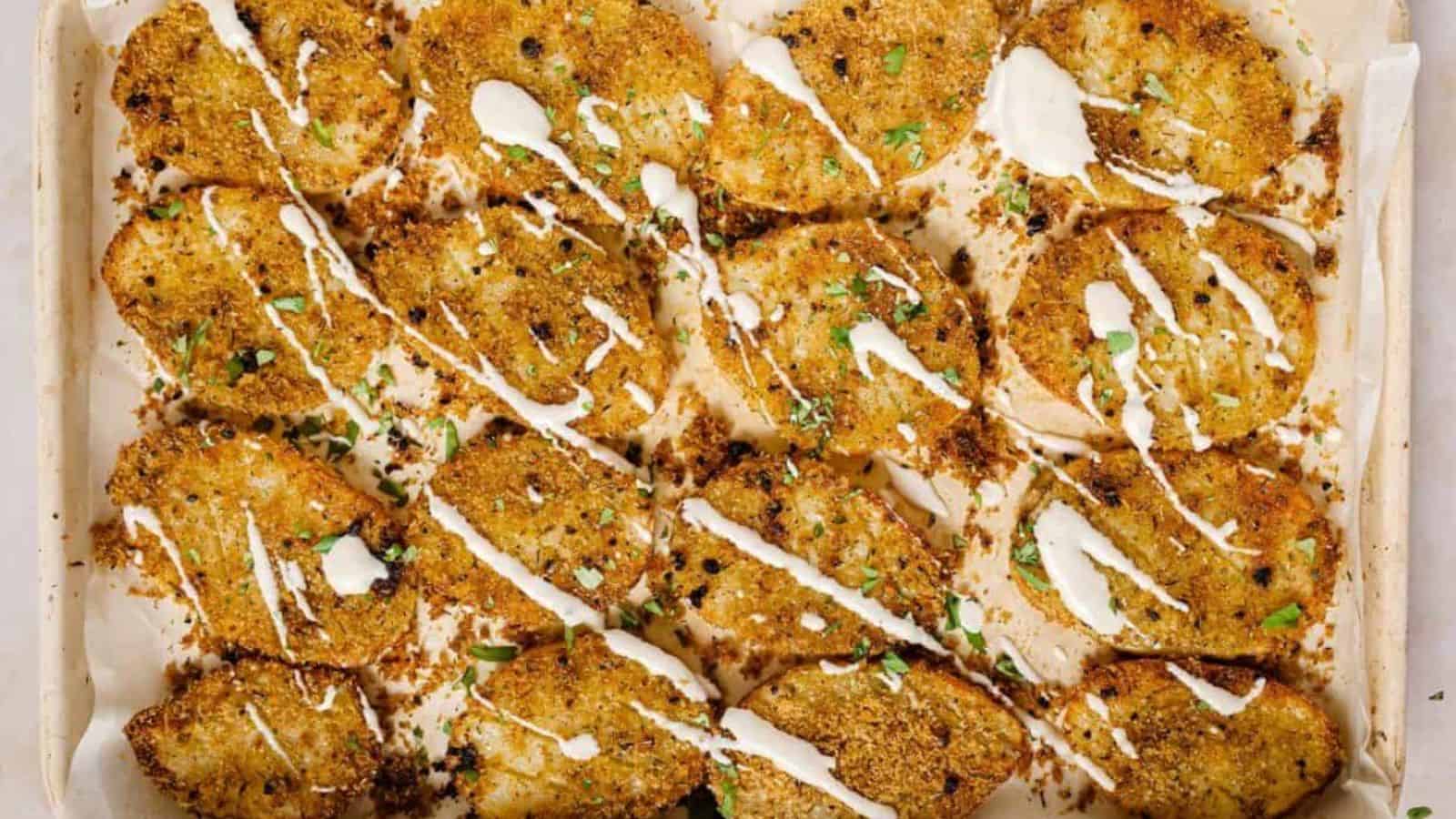 A baking sheet with garnished parmesan crusted potatoes on it.