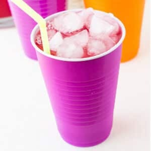 Solo cup with party punch in it with a yellow straw.