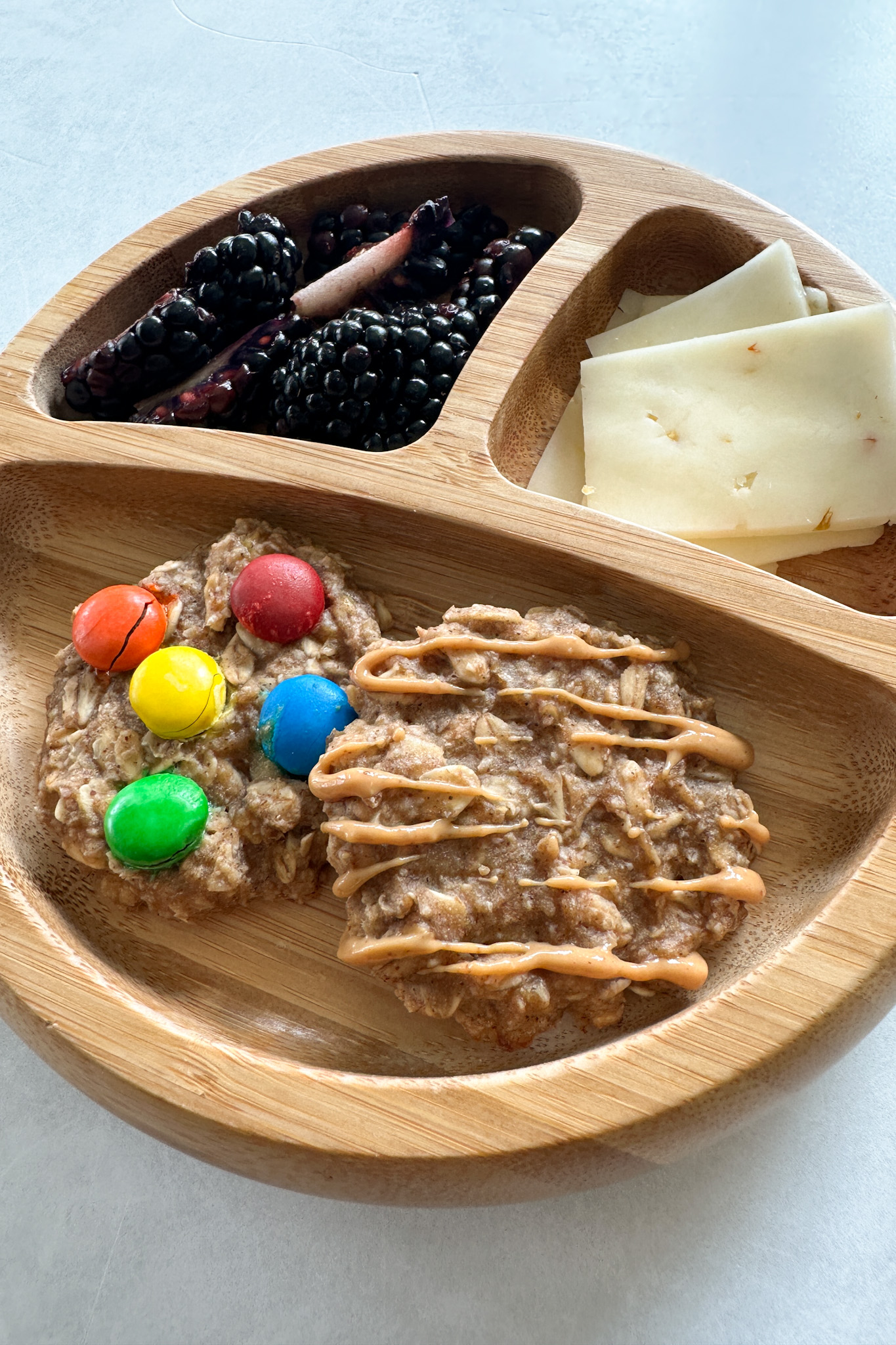 Peanut butter and banana cookies served with berries and cheese.