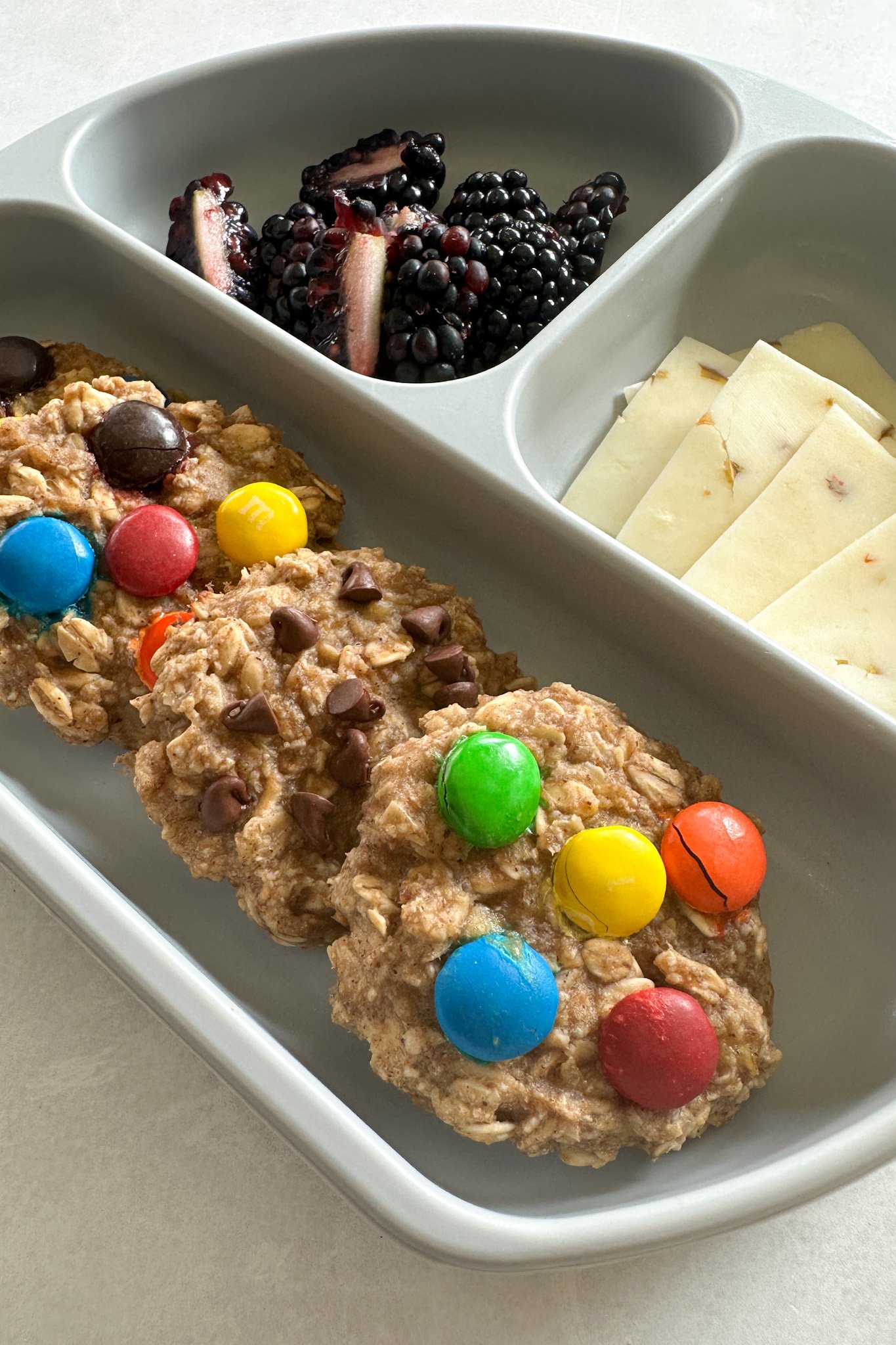 Peanut butter and banana cookies served with berries and cheese.