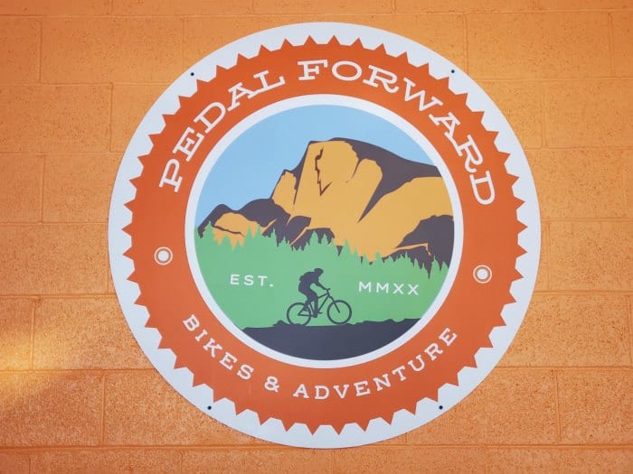 Pedal Forward Bike Shop sign with a biker on it