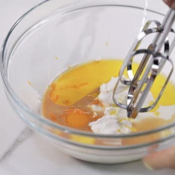 Egg, yogurt, buttermilk, olive oil, vanilla extract and orange zest in mixing bowl with hand held mixer.  