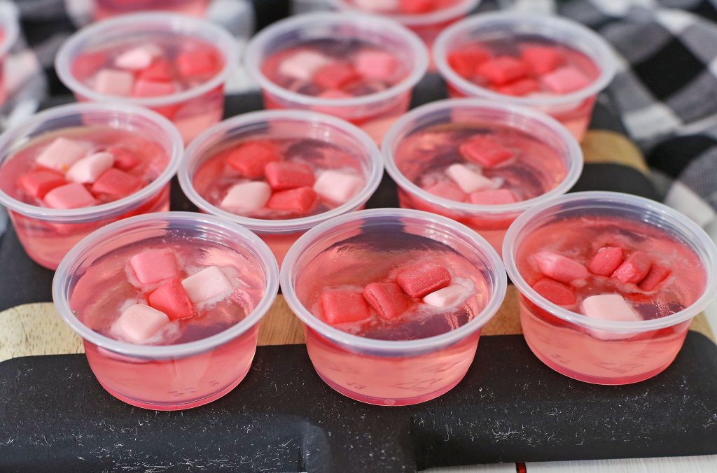 pink starburst jello cups on table