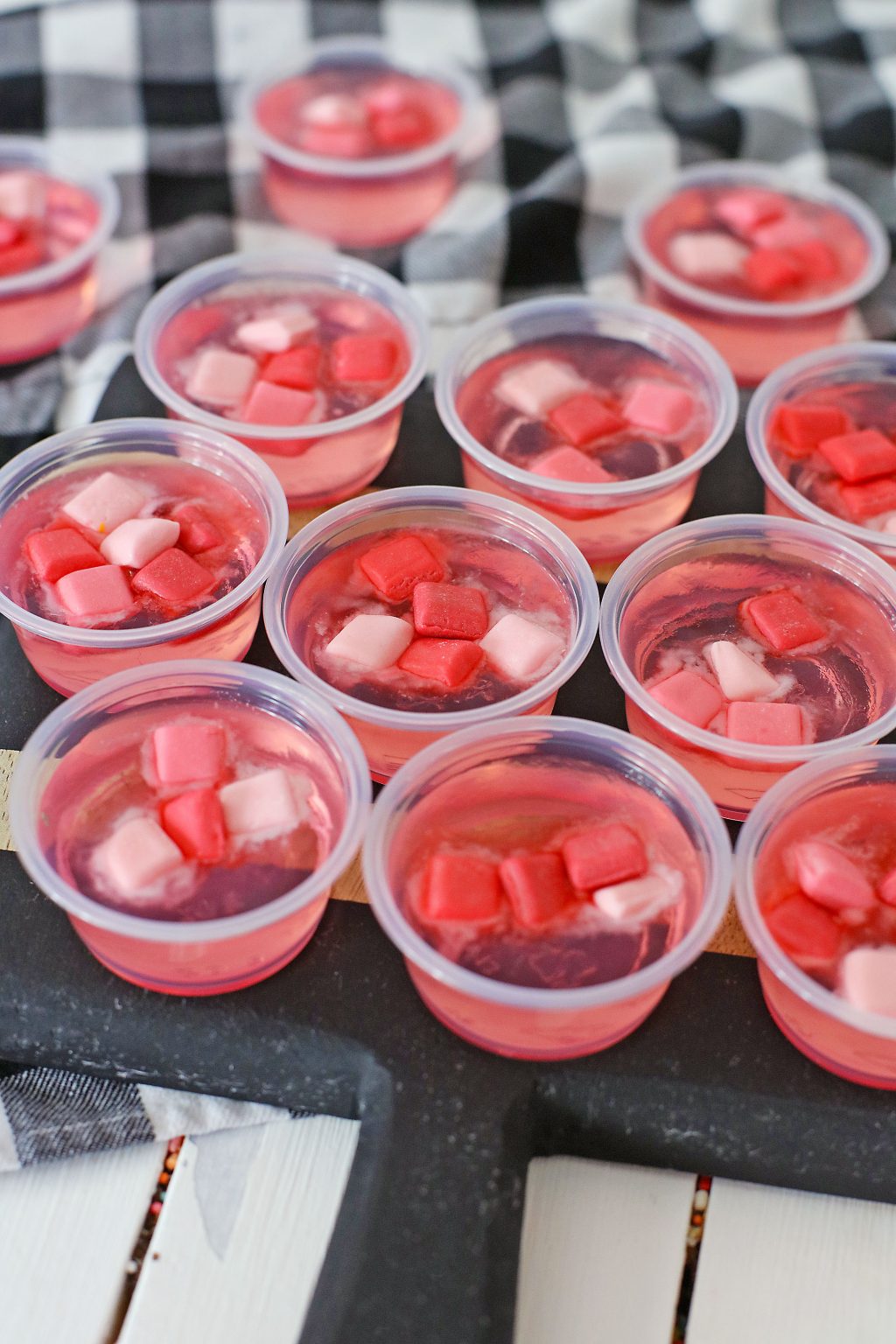 pink starburst jello cups on table