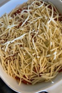 Pizza Potatoes is a pizza scalloped potatoes recipe with a box of scalloped potatoes, pepperoni, canned, diced tomatoes and shredded cheese.