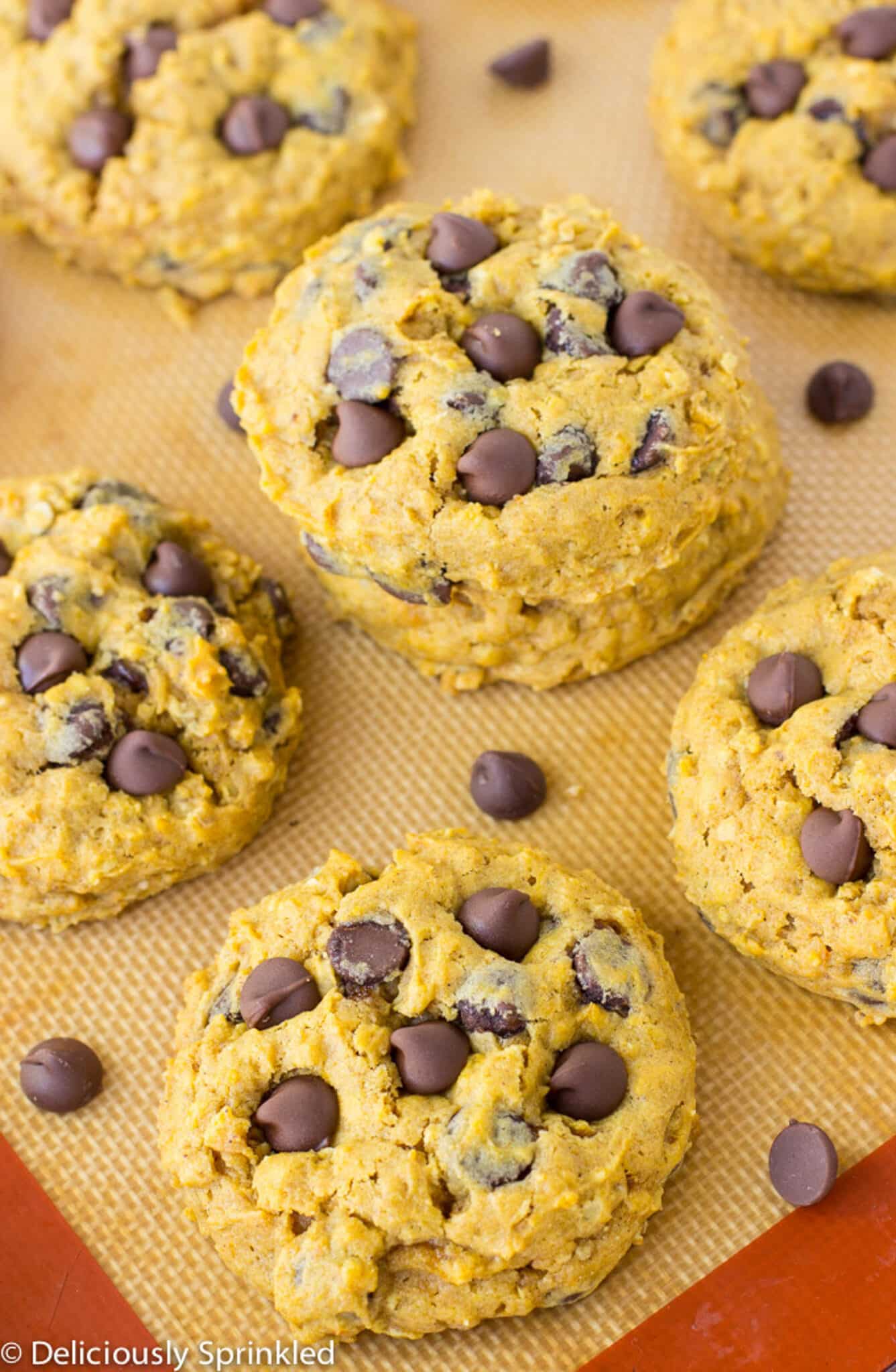 Pumpkin chocolate chip cookies on a baking tray.