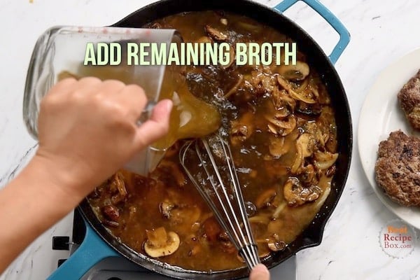 Pouring in remaining broth to the mushrooms and onions