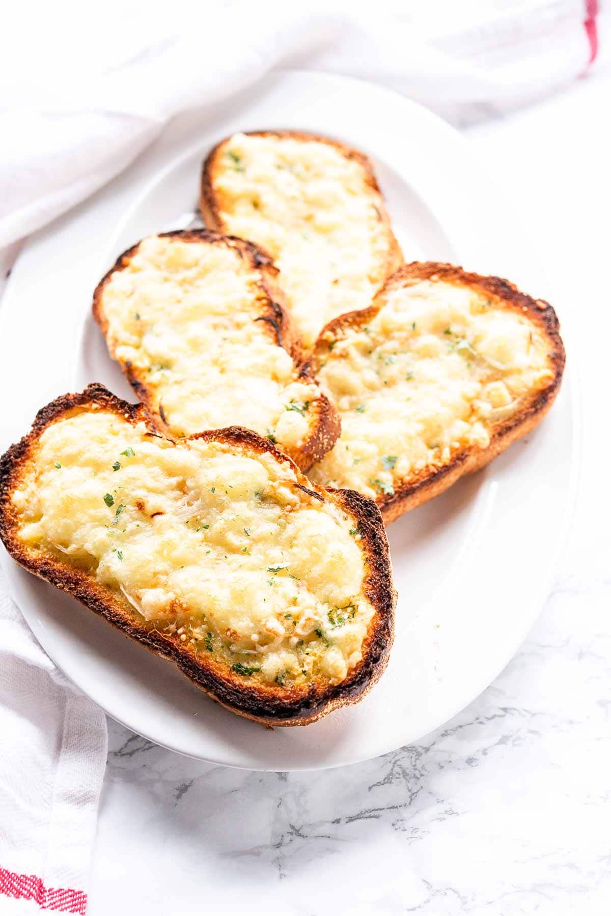Craving garlic bread with melted cheese but only want a slice take a look at this recipe. Quick and simple and so tasty. Serve as a side dish, appetizer or just for lunch.
