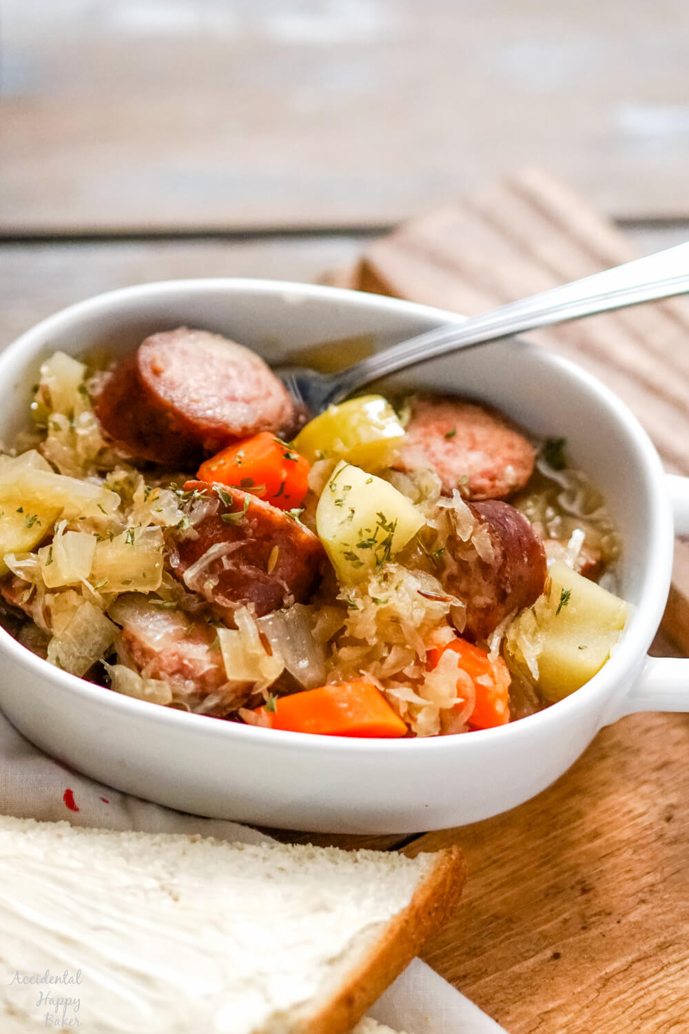 Kielbasa and sauerkraut are slow simmered with veggies, brown sugar, caraway and apple juice for a deliciously easy and comforting meal in the slow cooker.