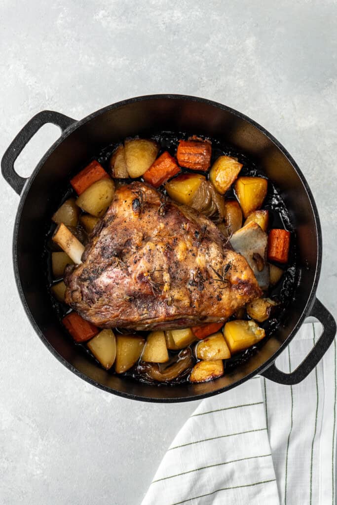 The cooked lamb and vegetables in the pot.