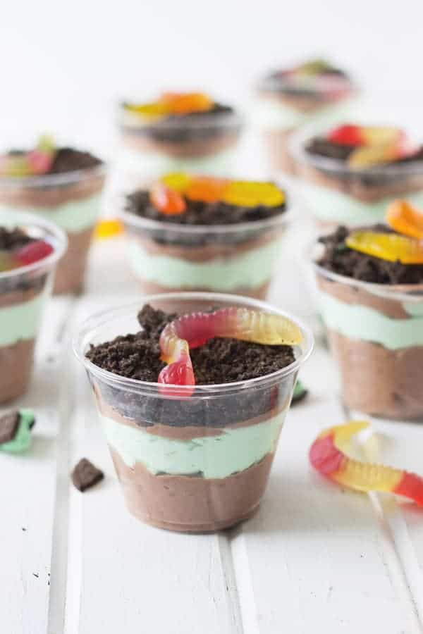 oreo and pudding dirt cups with worms all pictures on a white table surface