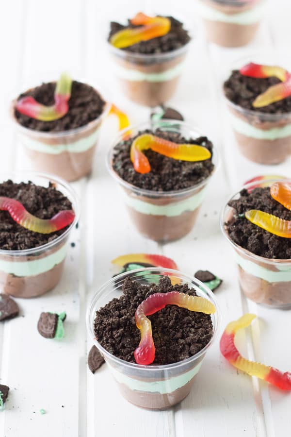 eight dirt cups garnished with gummy worms