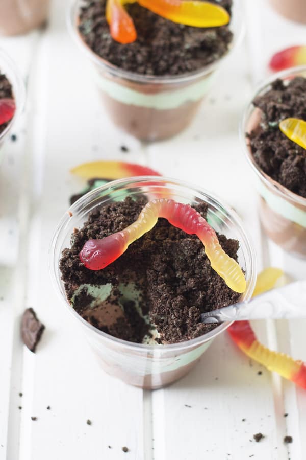 individual cups full of layers of pudding, whipped cream, and oreos