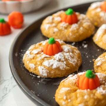 Baked pumpkin sugar cookies on plate.