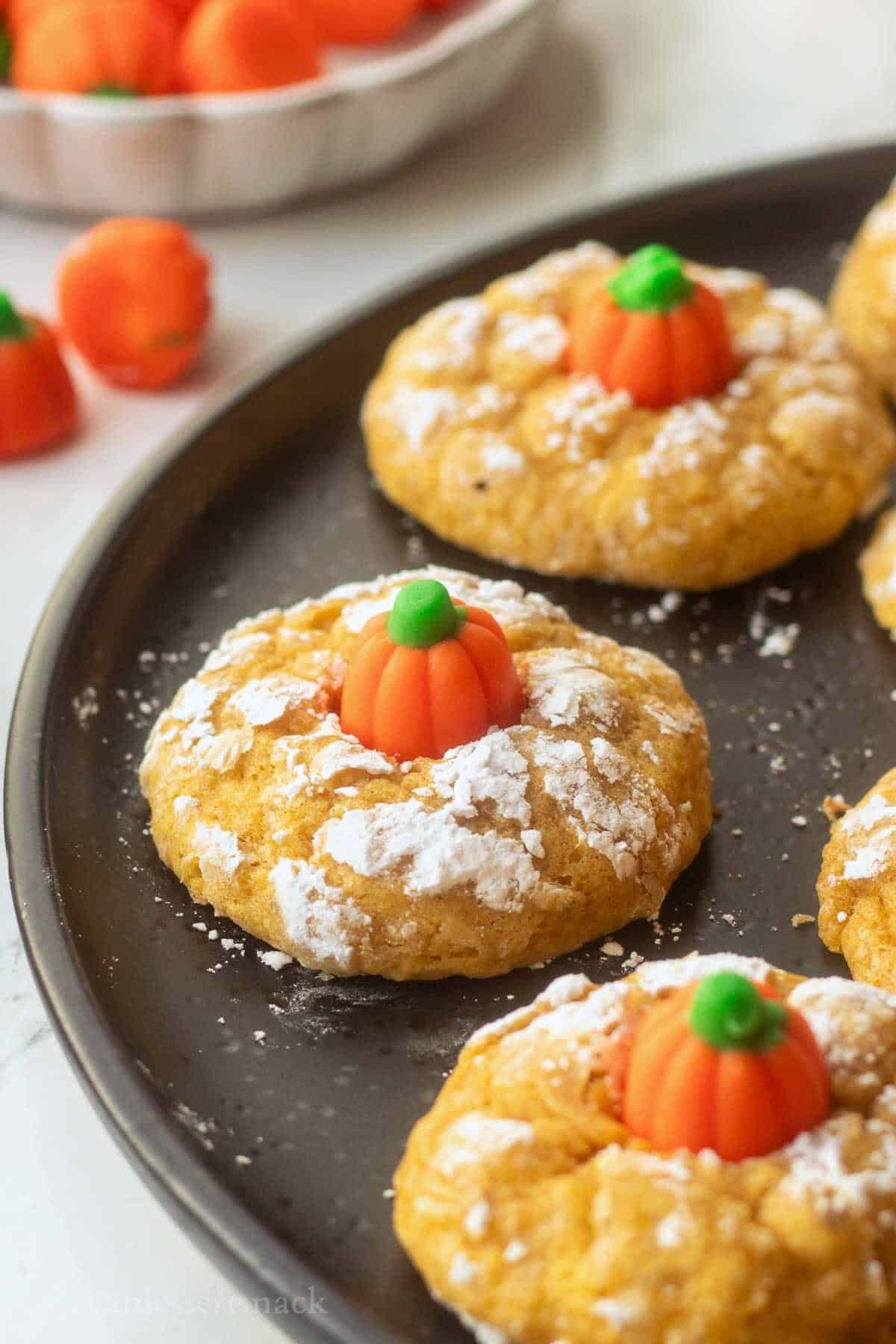 Baked pumpkin sugar cookies on plate.