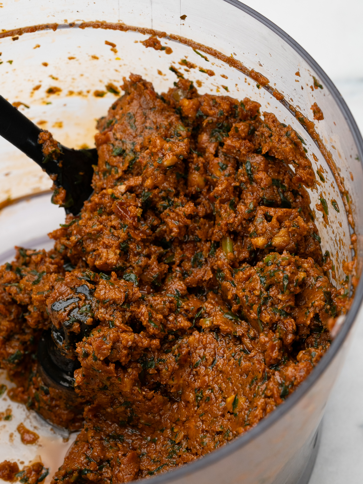 Close up of sundried tomaote pesto in food processor.
