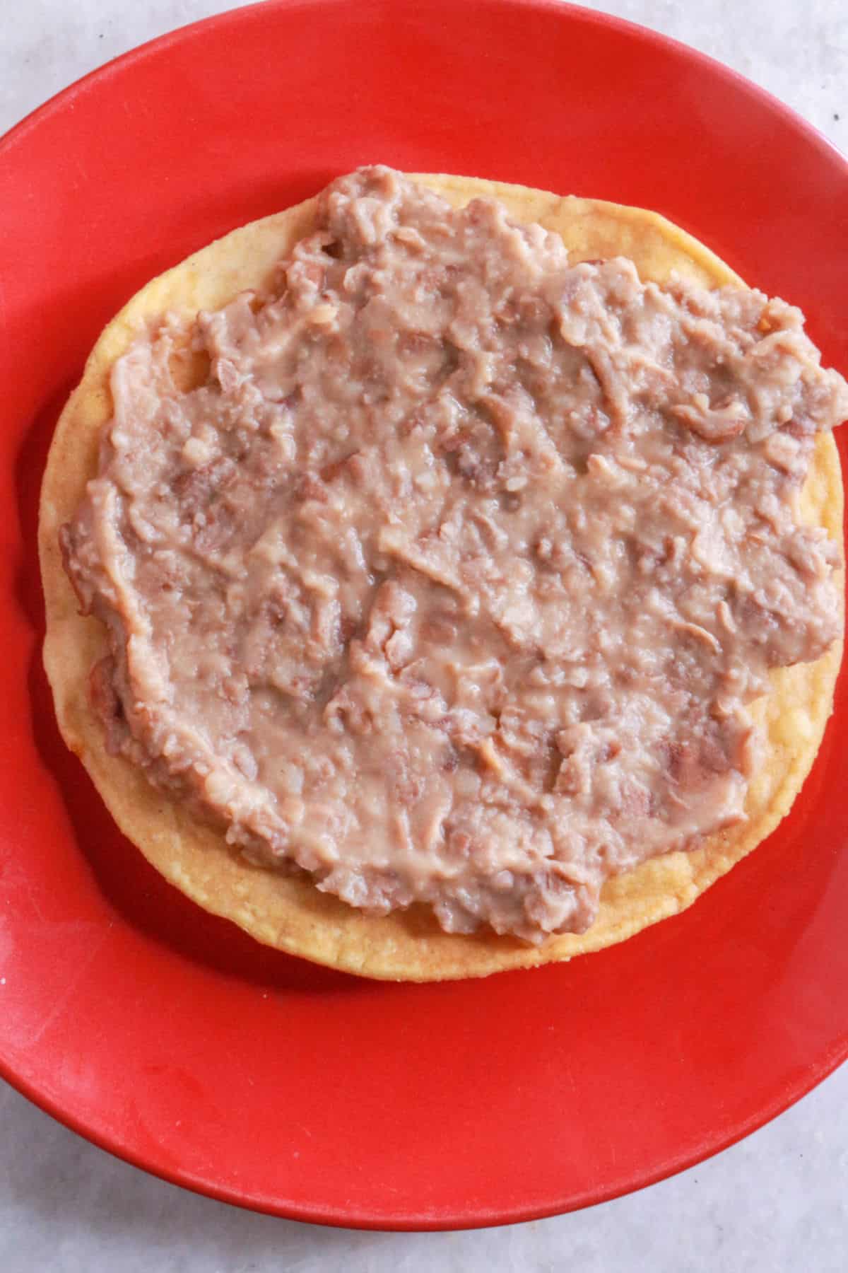A tostada with refried beans