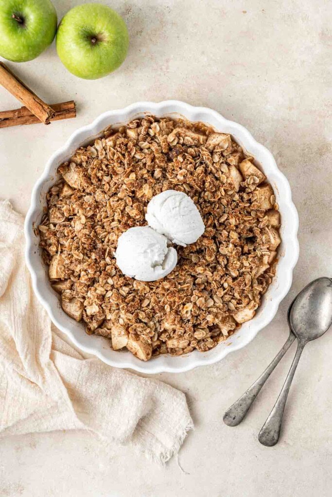 Freshly baked apple crumble with vanilla ice cream.
