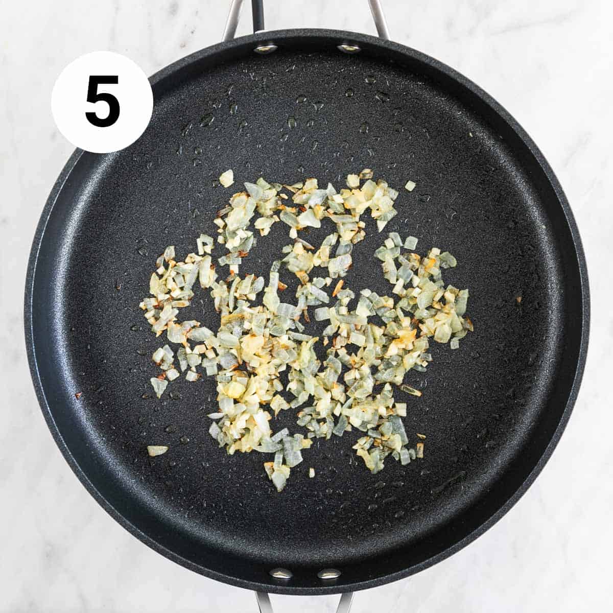 Sautéed onion and garlic in a skillet.