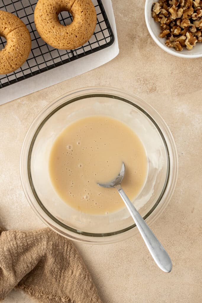 Mixing up the vegan maple glaze in a bowl.