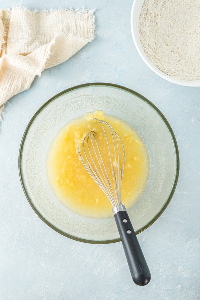 Whisking together the wet ingredients in a bowl.