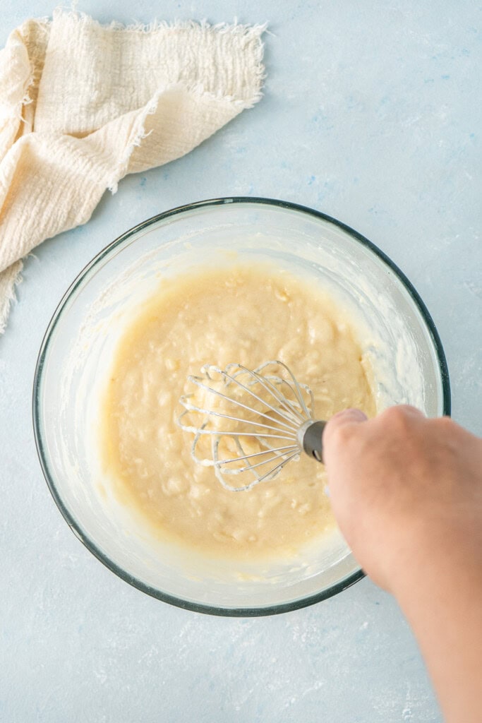 Whisking together the cupcake batter in a bowl.