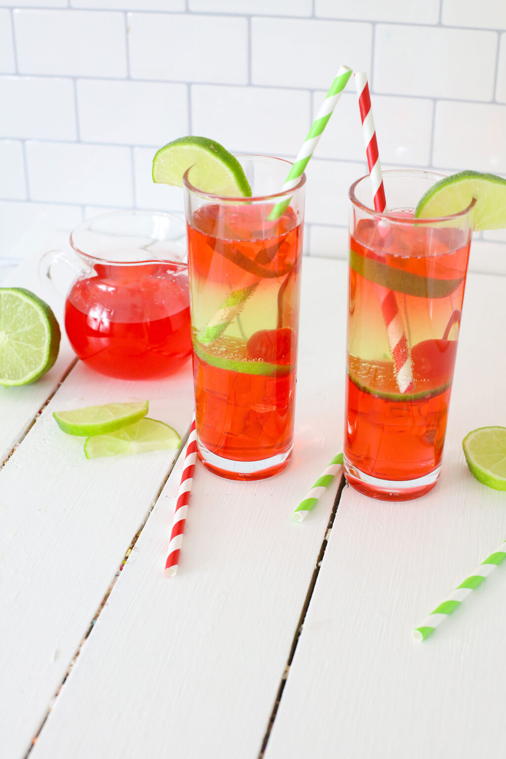 vodka cherry limeade cocktail in a tall glass with a straw